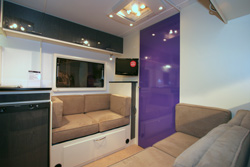 Lounge area with purple door into bedroom