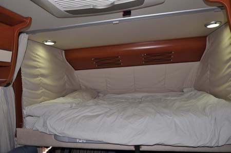 Luxury double bed inside the Hymer B544 motorhome 