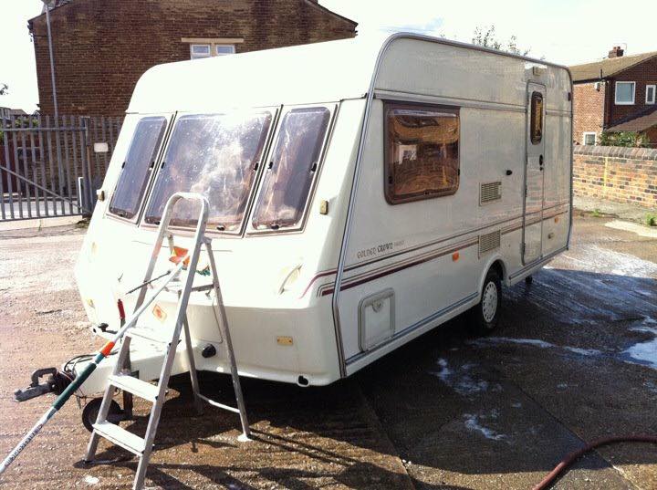 Caravan being cleaned with step ladder