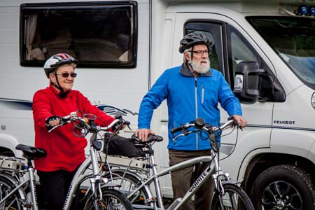 Cycling couple with motorhome