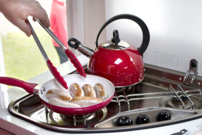 cooking breakfast sausages in pan