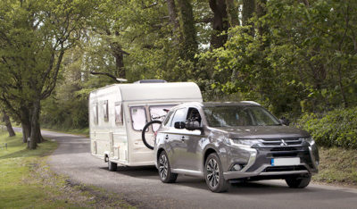 Hyrbid electric car towing caravan