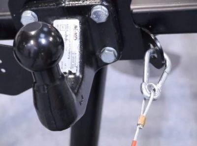 Carabiner breakaway cable attached to bolted tow bar with mounting point