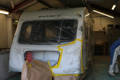 repairing a damaged caravan -wrapping it 