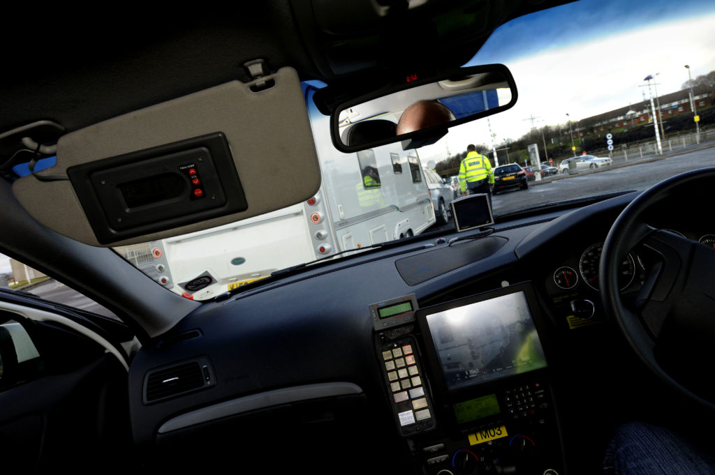 Police with TRACKER equipment in car