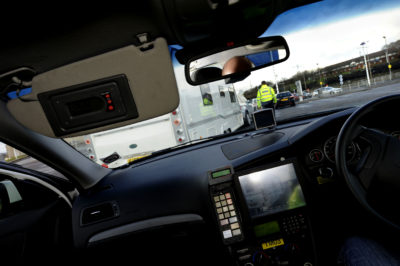 Police with TRACKER equipment in car