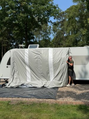 feeding the awning into the rail 