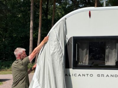 feeding the awning into the rail 