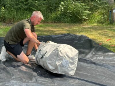 packing the awning into the bag
