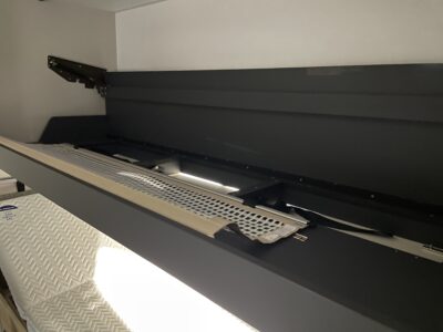 hidden single caravan bed in a locker